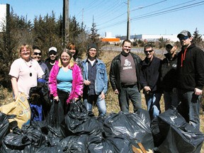 Participants in last year's trash bash show how much garbage they collected. This year's event is scheduled for April 25.