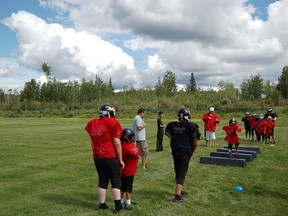 Janvier area youth participate in a football camp with the not-for-profit Tribal Dreams, run by Leroy Fontaine. Fontaine is leading the initiative to start a peewee football team in Janvier this season. SUPPLIED PHOTO