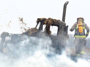 Perth East firefighters battled a stubborn fire of straw on a truck on Perth Roads 119 and 121 north of Stratford on Friday morning. (SCOTT WISHART, The Beacon Herald)