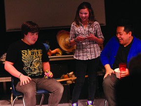 KEVIN RUSHWORTH HIGH RIVER TIMES. Levi Stimson, Clarissa McClurg and Andrew Phung, Loose Moose Theatre mentor, on stage at the Highwood High School improv tournament, held April 13.