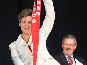 Lori MacDonald, the new chair of the United Way campaign, holds up the red suspenders that serve as the unofficial badge of office for the post as Lloyd Fleming, the outgoing chair, looks on during Friday's morning's appreciation breakfast for volunteers.
Michael Lea The Whig-Standard