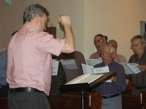 Loyal Beggs directs The North Channel Community Singers.