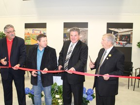 Brant MPP Dave Levac, left, BGI Retail president Kristian Carson, MP Phil McColeman and County of Brant Mayor Ron Eddy cut the ribbon on the BGI Retail's new facility in Paris, the first to open in the Brant 403 Business Park near Highway 403 and Rest Acres Road. MICHAEL PEELING/The Paris Star/QMI Agency