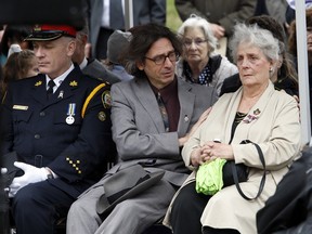 Barbara Irwin, with sons Stephen and John, at a dedication ceremony Friday, April 19, 2013, for a bridge in memory of her husband, Toronto Police Const. Michael Irwin, and fellow officer Douglas Sinclair, who were slain in 1972. (MICHAEL PEAKE/TORONTO SUN)