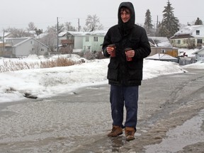 Timmins resident Corey Fex gives up trying to avoid the puddles left behind by steady rainfall and snow melts over the past two days. A dutiful Fex scored points with his girlfriend (we hope) after braving the rain, wind and slush for a coffee run.