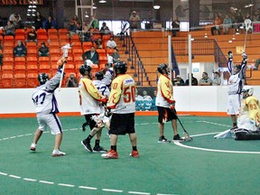 Iroquois Ironmen celebrated a tie-breaking, game winning goal by Ironmen's Chris Attwood (77) during a quarter-final game against Ohsweken Demons last Sunday at the Iroquois Lacrosse Arena. (Kara Wilson For The Expositor)