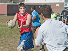 Jacob LeBlanc (left) passes the ball to a team mate during a senior boys rugby practice on Wednesday at St. John's College in Brantford. (BRIAN THOMPSON The Expositor)