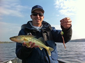 Erik Luzak holds a walleye caught on a worm harness at the 2011 Kiwanis Walleye World Live Release Derby.