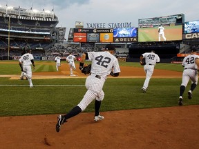 New York Yankees players, all wearing No. 42 to honour Hall of Fame player Jackie Robinson, take the field before a game with the Arizona Diamondbacks at Yankee Stadium on April 16

REUTERS/Ray Stubblebine