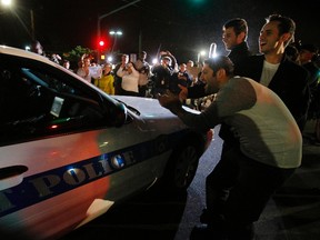 Members of the public cheer as police officers leave the scene where Dzhokhar Tsarnaev, the surviving suspect in the Boston Marathon bombings, was taken into custody in Watertown, Massachusetts April 19, 2013. (REUTERS/Brian Snyder)