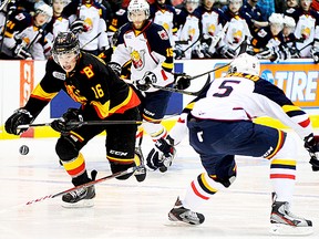 Belleville Bulls captain Brendan Gaunce tries to beat Barrie Colts defender Aaron Ekblad to a loose puck during OHL playoff action Friday night at Yardmen Arena. (Michael J. Brethour for The Intelligencer)