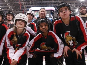 Eugene Melnyk offers kids hockey gear at charity skate. Tony Caldwell/Ottawa Sun