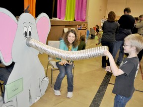 Joel Waldner, 6, feeds the elephant to win a prize at the Westpark School Carnival Friday. Manning the booth were Reighan Chiponski, right, and Samantha Balch.  (CLARISE KLASSEN/PORTAGE DAILY GRAPHIC/QMI AGENCY)
