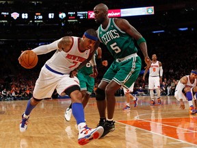 Knicks forward Carmelo Anthony drives to the basket defended by Celtics centre Kevin Garnett during Game 1 of their NBA Eastern Conference quarterfinal series at Madison Square Garden in New York, April 20, 2013. (ADAM HUNGER/Reuters)