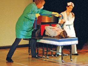 Magician John Kaplan gets some help from his assistant to saw volunteer Heather McBride in half Saturday at the Cultural-Recreational Centre. Kaplan’s show, called AbracaDAZZLE!, was brought to Vulcan as a fundraiser for the Vulcan Kinettes. His performance delighted many children who came out, and it also sparked plenty of laughter from the adults in the audience.