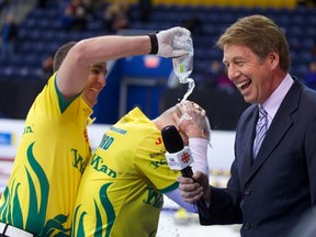 Glenn Howard gets a soaking from teammate Wayne Middaugh after their team won the Players' Championship curling title April 21, 2013, in Toronto. (ANIL MUNGAL/Sportsnet)