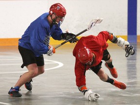 Owen Sound North Stars Garb and Gear Source for Sports Junior B lacrosse tryouts.
Micah Marcella (left) checks Ryan Hamelin to the floor during a one on one drill at the Owen Sound North Stars Garb and Gear Source for Sports Junior B lacrosse tryouts on Saturday April 20 2013 at the Shallow Lake Arena.