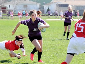 Carli Vaillancourt for the St. Clair Colts bolts through the defence of the LCCVI Lancers to score the first try of the game. The Colts beat LCCVI 15 to 10 in senior girls rugby action. BLAIR TATE / FOR THE OBSERVER / QMI AGENCY.