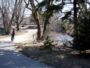 A cyclist rides along the Kinsman Trail between Duke and Chippewa streets, Monday, April 22, 2013. On Friday, Chippewa Creek overflowed its banks after two days of heavy rain, but the water subsided over the weekend. Both the Kinsman Trail and the Kate Pace Way were closed Friday because of high water.