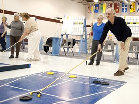 FILE PHOTO. Foothills Shuffleboard Association members Arnold Earl and Marlene Brunau enjoyed a night of shuffling Monday, April 15, 2013 at the Bob Snodgrass Recreation Complex.