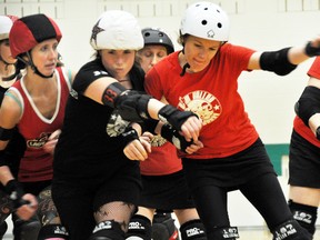 Genevieve “Gen-O-Side” Godbout pushes past Gemma “DoubleD-Struction” Oversby during the Lady Macs practice on Thursday, April 18. The season opener bout for the team is on Saturday, April 27 at the Canmore Rec Centre. Corrie DiManno/ Banff Crag & Canyon