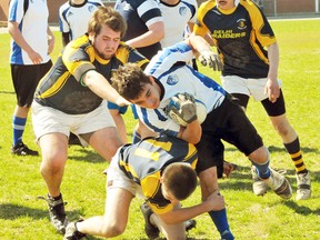 EDDIE CHAU Simcoe Reformer
Simcoe Sabres player Bill Bush-McHall, with ball, is attacked by members of the Delhi Raiders Rugby team during a game at Delhi District Secondary School Monday. Delhi won 24-5.