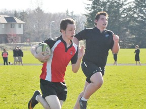 EDDIE CHAU Simcoe Reformer
Austin Logan, left, of the Waterford Wolves, runs past a member of the Holy Trinity Titans boy's rugby team during a game at Holy Trinity Monday afternoon. Waterford defeated Holy Trinity 51-0.