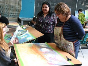 Edmonton-based artist Heather Shillinglaw, right, takes time Monday with a number of Composite High School students, including Grade 9 student Cierra Lowery, 15, as a part of an Alberta Foundation for the Arts grant. AMANDA RICHARDSON/TODAY STAFF