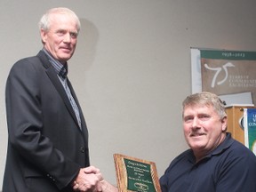 KEVIN RUSHWORTH HIGH RIVER TIMES. MD of Foothills councillor Ralph Nelson presents a plaque celebrating 75 years of Ducks Unlimited Canada (DUC) to Brian Chipchase, chairman of the local DUC chapter.