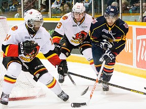 Jordan Subban and Niki Petti of the Belleville Bulls battle for possession of the puck with Andreas Athanasiou of the Barrie Colts during OHL playoff action Monday night at the Molson Centre. (David Zammit/Barrie Examiner)