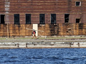 Workers with Crate Marine Sales of Keswick, Ont. and East Marina Investment Ltd. of Markham, Ont. start renovation of the former Morch Marine's building at 25 Dundas St. W. in Belleville and remove old docks out of the Bay of Quinte Monday. Crate's forthcoming condominium development project in the area. JEROME LESSARD The Intelligencer/QMI Agency