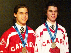 Cody and Jesse McIntyre wear their silver medals while sporting their Team Canada jerseys.