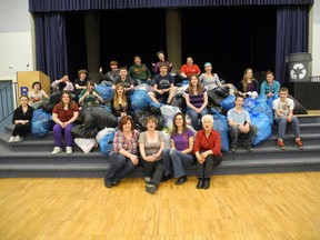 A Rothwell-Osnabruck School Grade 9 class, as well as members from the school council and Bag2 School program, sit with about two tonnes of clothing collected by students, parents and staff.  The school receives $200 per tonne of clothes collected to use towards school programs.
