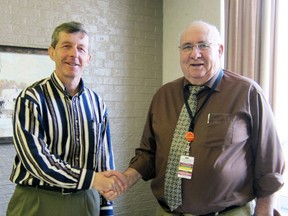 Stephen Tait (left), Board Chair, Alexandra Hospital, Ingersoll; and Duaine Nelson (right) Board Chair, Tillsonburg District Memorial Hospital shake hands after signing the Joint Venture Agreement between the two organizations. Contributed Photo