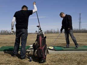 Shawn Wells (left), from Onoway, and James Monsees, from St. Albert,  practice their swings at Lone Spruce Driving Range in St. Albert, Alta., on Wednesday, April 17, 2013. (Ian Kucerak/Edmonton Sun)