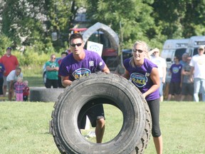 Bob and Christina Vandersluis flip a tire end over end as they near the completion of the Chatham-Kent Amazing Race 2012. (QMI Agency file photo)