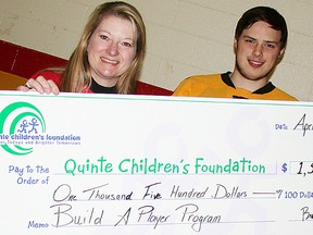 Connie Reid, executive director of Quinte Children's Foundation, accepts a cheque for $1,500 from Belleville Bulls captain Brendan Gaunce for the Build A Player program, Tuesday at Yardmen Arena. (Paul Svoboda/The Intelligencer)