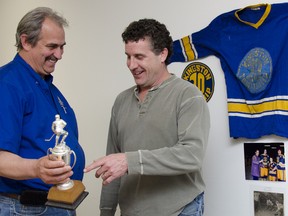 Darrell Townsend, left, and Andrew Perrett reminisce about their 1972-73 Kingston Township major peewee A team, which won an Ontario Minor Hockey Association championship. (Julia McKay/For The Whig-Standard)