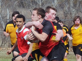 Centre Hastings Centurions' Jesse Corbeil wraps up Bayside Red Devils' Justin Hall during Bay of Quinte senior boys rugby exhibition play Thursday at Bayside Secondary School. The Red Devils scored on the final play of the game to salvage a 12-12 tie.