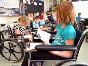 Neylan Rothernel, right, 10, and Sammy Evans, 11, were among a class of Grade 5/6 pupils at Avon Public School who got a glimpse of what school can be like for the disabled when they spent two days this week in wheelchairs. (SCOTT WISHART, Beacon Herald)