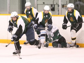 The Widdifield Wildcats won the annual junior high school hockey showcase tournament at Pete Palangio arena, Monday. Above, Scollard Bears player Michael Silveri, picked by the Sudbury Wolves in the sixth round of the OHL Priority Selection, goes on the attack against the West Ferris Trojans.