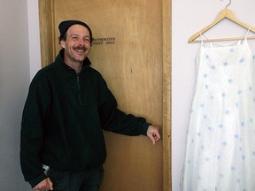 A St. Vincent de Paul volunteer with an example of the fashion show wardrobe.
Photo by KATHY HOLT/FOR THE STANDARD