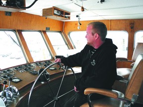 Matt Harper, shop foreman of the Gananoque Boat Line, looks out the window of the wheelhouse of 1000 Islander 3, as he prepares the comany's boats for the coming tourism season.
Wayne Lowrie/Gananoque Reporter