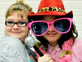 Shae-Lynn Hagerty, 17, and Micaela Lewies, 14, strut their stuff for the photo booth at the sixth annual Spring Fling held at John McGregor Secondary School. The event highlights the end of the year for developmentally delayed and medically fragile high school students from Chatham, Blenheim and Wallaceburg. PHOTO TAKEN: Chatham, On., Wednesday, April 24, 2013. DIANA MARTIN/ THE CHATHAM DAILY NEWS/ QMI AGENCY