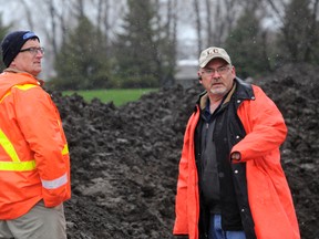 Sarnia Public Works Operations Manager Bryan Prouse (left), talks with Dave Meyers about the work that needs to be done in Cenntenial Park. Drenched workers from the  public works department began digging in and around Centennial Park children's play area due to high levels of lead. The play area will be closed off to the public until the ministry has tested the area. BLAIR TATE / FOR THE OBSERVER / QMI AGENCY