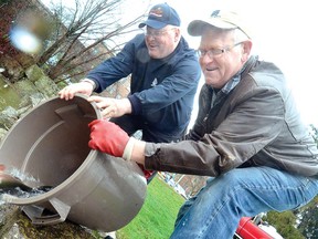 Stratford Optimists Dale Bast, left, and Barry Mason help stock the Avon River on Wednesday with some of more than 1,000 rainbow trout for this Saturday's annual trout derby. (SCOTT WISHART Staff photographer)