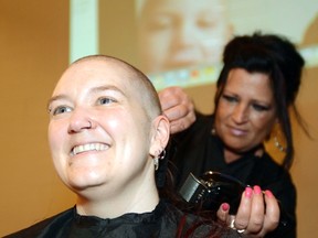 Paula Vandelaar of Stellar Hair & Tattoo’s shaves Angela Schmidt’s head at Glenbow school as students shaved their heads to support Angela’s son Paxton Carroll, who is currently fighting cancer. Paxton is seen in the background via Skype as the schools event took place on April 19, in Cochrane.