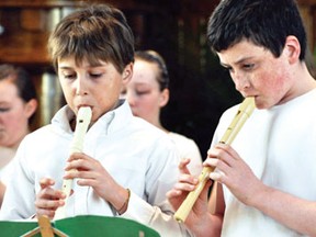 Two boys from Hilary Aitken’s Recorder Group play their instruments during their performance of Ode to Joy and This Little Light of Mine.