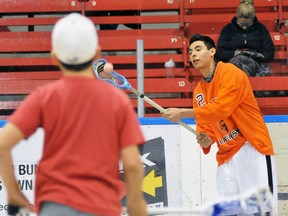 EDDIE CHAU Simcoe Reformer
Six Nations Junior B Rebels player Alex Henry (right) plays catch with a member of the Norfolk Timberwolves during Simcoe Minor Lacrosse's sixth annual Family Fun Night Wednesday at Talbot Gardens.