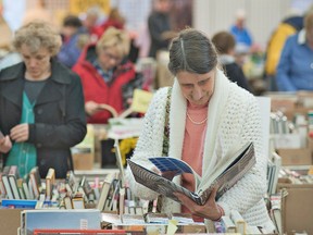 People flip through titles on the opening day of the annual Brantford Symphony Orchestra Women's Committee annual book fair on Wednesday. (BRIAN THOMPSON The Expositor)